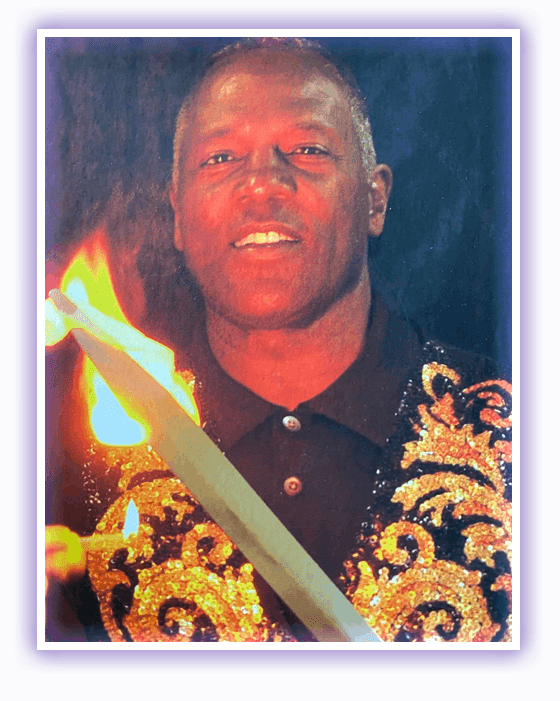 A man with a sword and fire in the background.